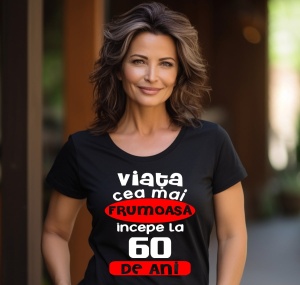 Femeie care poartă un tricou negru personalizat cu mesajul: ''Viata cea mai frumoasa incepe la 60 de ani''.