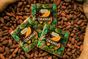 Mini delicii GALFFIS – ciocolată neagră cu cremă de portocale, 20 g – prezentare pe pat de boabe de cacao