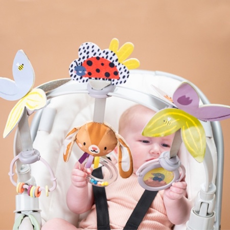 Detalj ogledala i zveckavih perlica na luku za bebe